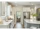 Well-lit kitchen with stainless steel appliances, a gas stovetop, white cabinets, and hardwood floors at 4045 Oxeye Loop, Johns Island, SC 29455