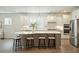 Bright kitchen with stainless steel appliances, gas cooktop, a unique island with seating, and hardwood floors at 4045 Oxeye Loop, Johns Island, SC 29455