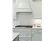 Close up of kitchen featuring white cabinets, stainless appliances, and a gas stovetop with subway tile backsplash at 4045 Oxeye Loop, Johns Island, SC 29455