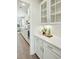 Bright kitchen featuring white cabinets, modern appliances, subway tile backsplash, and wood flooring at 4045 Oxeye Loop, Johns Island, SC 29455
