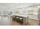 Spacious open concept kitchen with island, seating, stainless appliances, and hardwood floors to living at 4045 Oxeye Loop, Johns Island, SC 29455