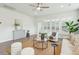 Airy living room with large windows, a decorative cabinet, and a comfortable seating area at 4045 Oxeye Loop, Johns Island, SC 29455