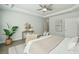 A beautifully designed main bedroom with trey ceiling, ceiling fan, sitting area, and light, neutral decor at 4045 Oxeye Loop, Johns Island, SC 29455