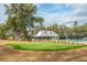 Enjoy community amenities, including a putting green and swimming pool behind a white building at 4045 Oxeye Loop, Johns Island, SC 29455