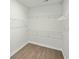 A walk-in closet featuring laminated wood floor and wire shelving for optimized storage solutions at 4045 Oxeye Loop, Johns Island, SC 29455
