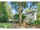 Expansive backyard featuring a deck, patio, and lush trees offering shade and privacy at 405 Springfield Rd, Mount Pleasant, SC 29464