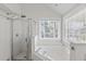 Bright bathroom with a glass enclosed shower and large soaking tub under a window at 405 Springfield Rd, Mount Pleasant, SC 29464