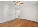 Neutral bedroom featuring hardwood floors, a ceiling fan, closet doors, and an open doorway at 405 Springfield Rd, Mount Pleasant, SC 29464