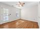 Spacious bedroom showcasing neutral walls, hardwood floors, a ceiling fan, and a glass door to the outside at 405 Springfield Rd, Mount Pleasant, SC 29464