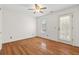 Simple bedroom featuring hardwood floors, ceiling fan, and a door leading to the outside at 405 Springfield Rd, Mount Pleasant, SC 29464