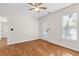 An inviting bedroom with hardwood floors, a ceiling fan, white walls, and access to an adjacent room at 405 Springfield Rd, Mount Pleasant, SC 29464