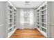 Bonus room features hardwood floors, neutral walls, and a built in bookcase with bright lighting at 405 Springfield Rd, Mount Pleasant, SC 29464