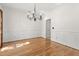 Elegant dining room featuring hardwood floors, wainscoting, and a stylish chandelier at 405 Springfield Rd, Mount Pleasant, SC 29464