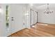 Inviting foyer with front door, sidelights, and hardwood floors, leading to an elegant dining area at 405 Springfield Rd, Mount Pleasant, SC 29464
