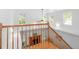 Bright foyer showcasing the staircase with wood banister overlooking the living room with a fireplace at 405 Springfield Rd, Mount Pleasant, SC 29464