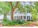 Charming two-story home with a welcoming front porch, balcony and lush landscaping at 405 Springfield Rd, Mount Pleasant, SC 29464