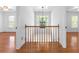 Hallway with hardwood floors featuring natural light and decorative chandelier at 405 Springfield Rd, Mount Pleasant, SC 29464