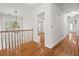 Upstairs hallway with hardwood floors, natural lighting, and decorative chandelier at 405 Springfield Rd, Mount Pleasant, SC 29464