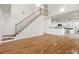 Bright open-concept living area with hardwood floors, staircase, and access to a modern kitchen at 405 Springfield Rd, Mount Pleasant, SC 29464