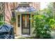 Charming back entrance with a classic door, lush greenery, and architectural details, inviting a warm welcome at 41 Tradd St, Charleston, SC 29401