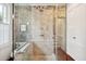 Shower featuring glass enclosure, tiled walls, and natural light from a window at 41 Tradd St, Charleston, SC 29401