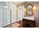 Bathroom with exposed brick, shower, vanity, and ample lighting at 41 Tradd St, Charleston, SC 29401