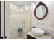 Elegantly designed bathroom featuring marble shower, unique sink and an ornate mirror at 41 Tradd St, Charleston, SC 29401