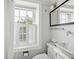 Well-lit bathroom with a modern vanity, a stylish faucet, and a bright window at 41 Tradd St, Charleston, SC 29401