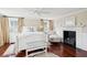 Serene bedroom featuring a cozy fireplace, hardwood floors, and a comfortable seating area at 41 Tradd St, Charleston, SC 29401