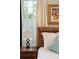Close-up of a bedroom highlighting the rustic bed frame, bedside table with a lamp, and a window at 41 Tradd St, Charleston, SC 29401