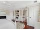 Bright bedroom with a fireplace, hardwood floors, and a comfortable bed with a floral rug at 41 Tradd St, Charleston, SC 29401