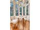 Charming breakfast nook with a round table and garden views through large windows at 41 Tradd St, Charleston, SC 29401