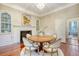 Dining room with hardwood floors, a round table and seating, fireplace, and a decorative chandelier at 41 Tradd St, Charleston, SC 29401