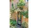 Charming brick house entrance with a unique door and lush greenery, creating an inviting curb appeal at 41 Tradd St, Charleston, SC 29401