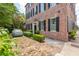 Charming brick home with lush landscaping, featuring a paved driveway and classic architectural details at 41 Tradd St, Charleston, SC 29401