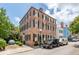 Classic brick home featuring black shutters and a well-manicured lawn on a sunny day at 41 Tradd St, Charleston, SC 29401