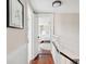 Hallway leading to a bedroom, showcasing hardwood floors and providing a glimpse of a beautifully furnished space at 41 Tradd St, Charleston, SC 29401
