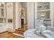 Elegant kitchen with brick accents, modern appliances, and a view into the living room at 41 Tradd St, Charleston, SC 29401