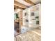Bright kitchen featuring exposed brick accents and a built in bookshelf at 41 Tradd St, Charleston, SC 29401