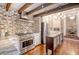 Modern kitchen with stainless steel appliances, brick accents, and an island with seating at 41 Tradd St, Charleston, SC 29401