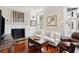Living room with hardwood floors, fireplace, modern lighting, and traditional furnishings at 41 Tradd St, Charleston, SC 29401