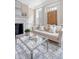 Bright living room featuring fireplace, a comfortable sofa, and a glass coffee table on an area rug at 41 Tradd St, Charleston, SC 29401