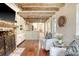 Cozy living room featuring exposed beam ceiling, a brick fireplace, and stylish armchairs at 41 Tradd St, Charleston, SC 29401