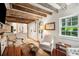 Elegant living room showcasing exposed beams, hardwood floors, and a view into the kitchen at 41 Tradd St, Charleston, SC 29401