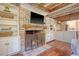 Inviting living room with a brick fireplace and built-in shelving and wooden beam ceiling at 41 Tradd St, Charleston, SC 29401