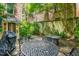 Charming brick patio featuring outdoor dining set, adjacent to lush landscaping and classic brick architecture at 41 Tradd St, Charleston, SC 29401