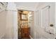 Quaint powder room with a vessel sink, brick accent wall, and a decorative mirror at 41 Tradd St, Charleston, SC 29401