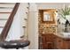 Charming powder room with a vessel sink, brick wall, and vintage-style mirror at 41 Tradd St, Charleston, SC 29401