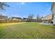 Wide view of the level, grassy backyard with a patio, perfect for relaxing and entertaining at 521 Holiday Dr, Summerville, SC 29483