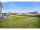 Well-kept backyard with a patio seating area, privacy fence, and lush green lawn at 521 Holiday Dr, Summerville, SC 29483